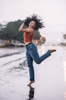 woman in blue denim jeans standing on water during daytime