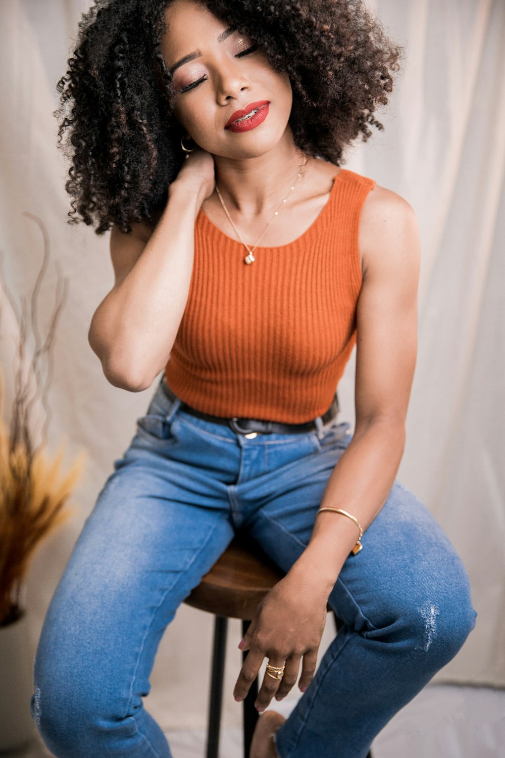 a woman sitting on top of a wooden chair