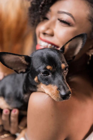 A cheerful Mexican model holding a leash with a happy dog, showcasing trust and care.