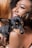 a woman holding a small black and brown dog