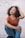 a woman sitting on the ground with her hands on her head