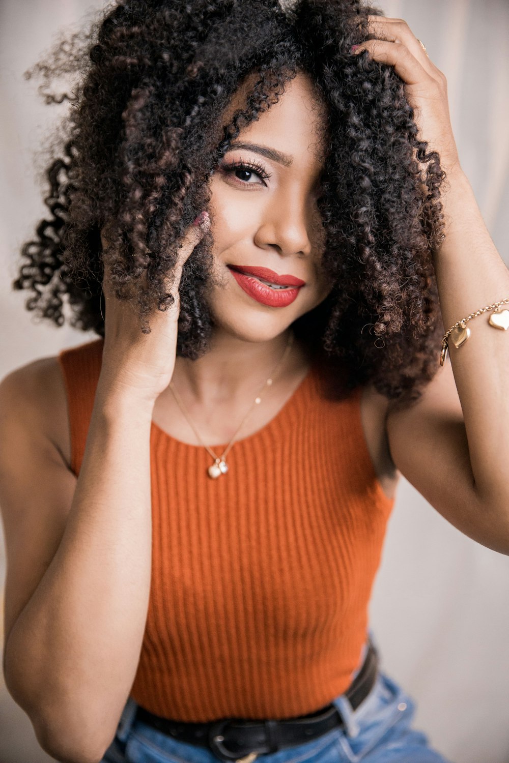 a woman with curly hair posing for a picture