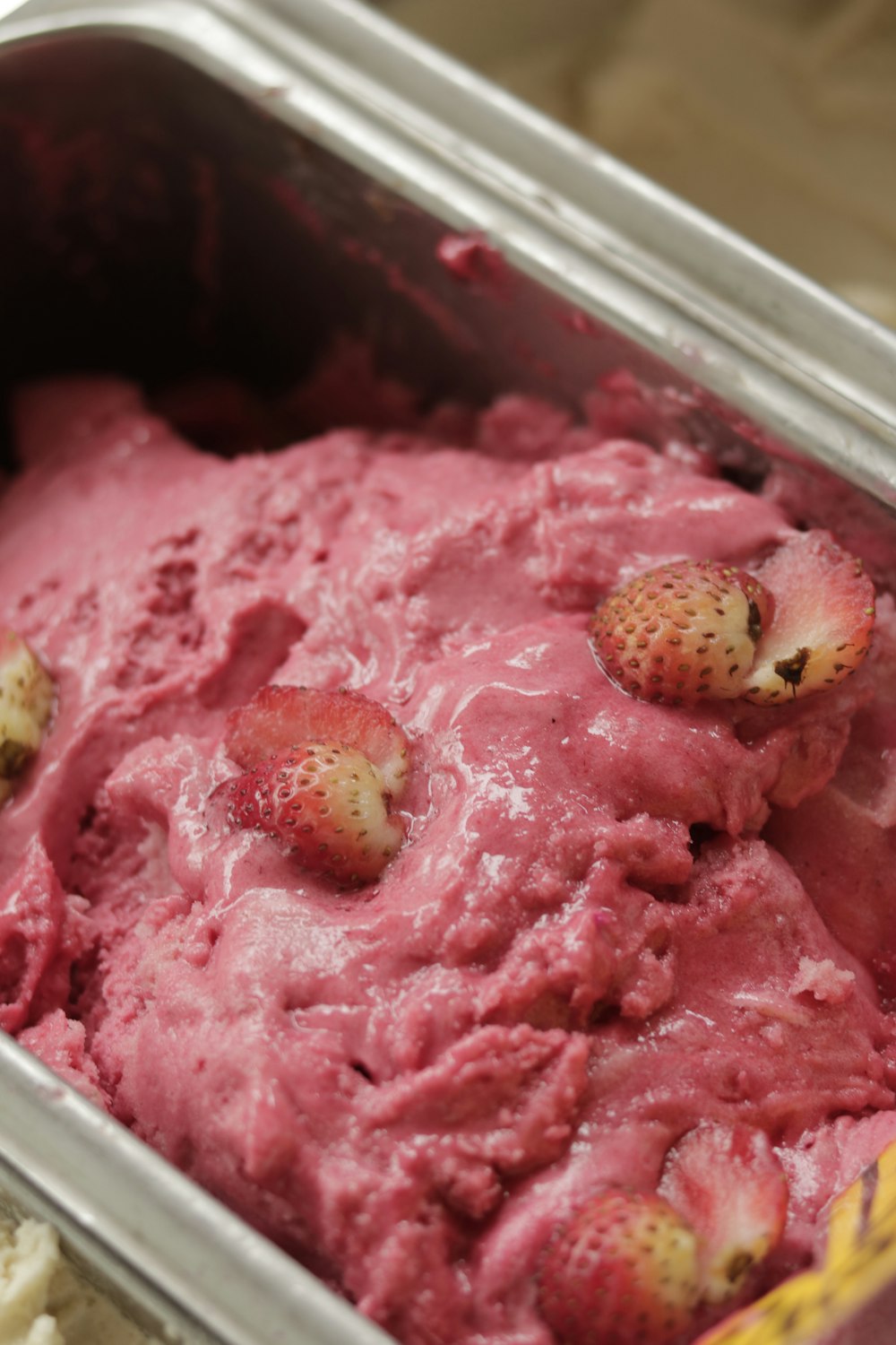 strawberry ice cream in clear plastic container