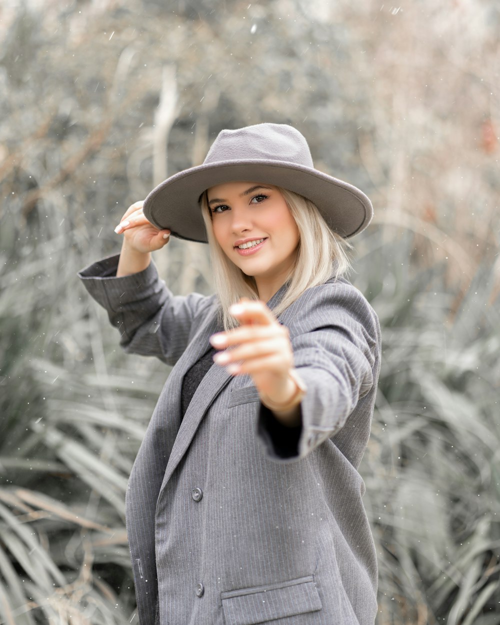 woman in gray coat and black hat