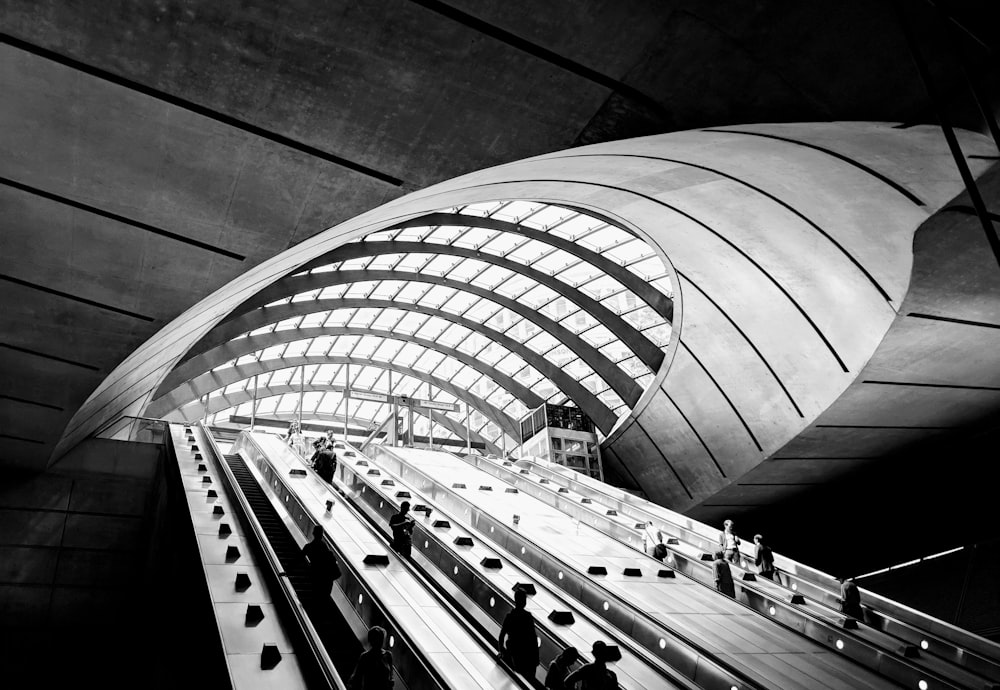 grayscale photo of people walking on stairs