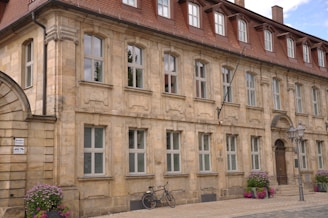 Historic brick building with restored facade and flower boxes.