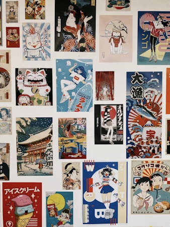 A collection of various Japanese-style posters and illustrations arranged in a collage. The images feature colorful and diverse themes, including traditional Japanese art, anime-style characters, and modern pop art elements. There are depictions of characters in dynamic poses, a Maneki-neko (lucky cat), and scenes with cultural motifs.
