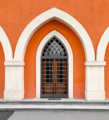 Stylish storm door with orange accents installed on a family home.
