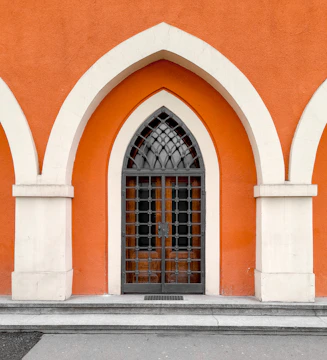 Stylish storm door with orange accents installed on a family home.
