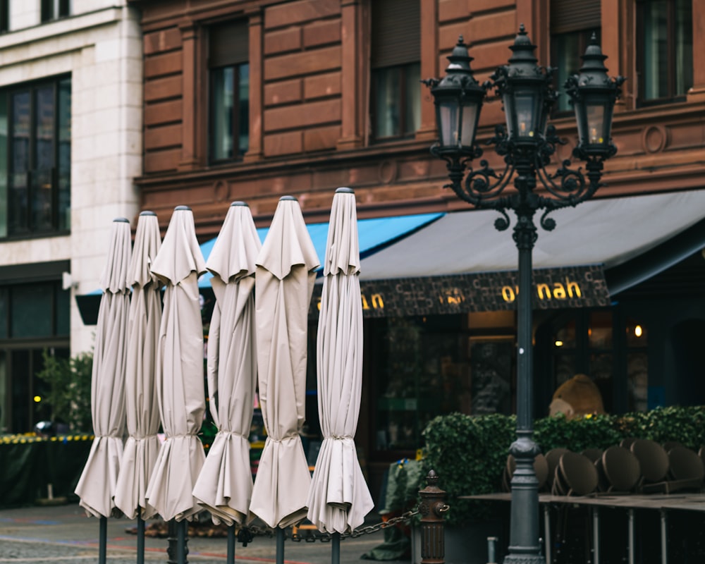 white textile hanging on black steel fence