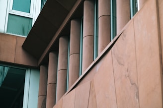 Architectural building facade clad in finely polished stone panels.
