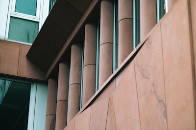 Architectural building facade clad in finely polished stone panels.