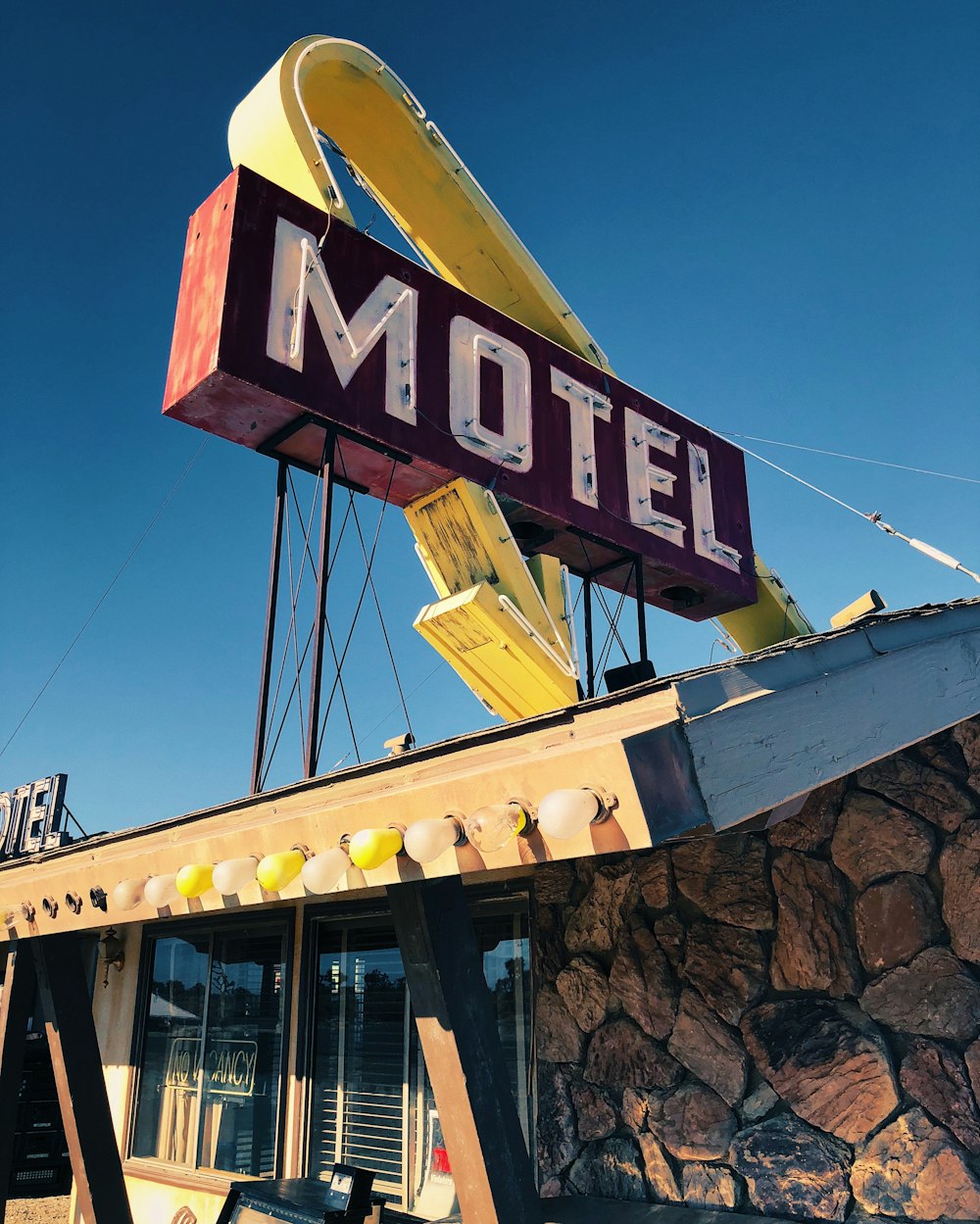 a motel with a large neon sign on top of it