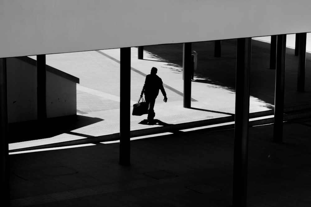 woman in black jacket walking on the sidewalk