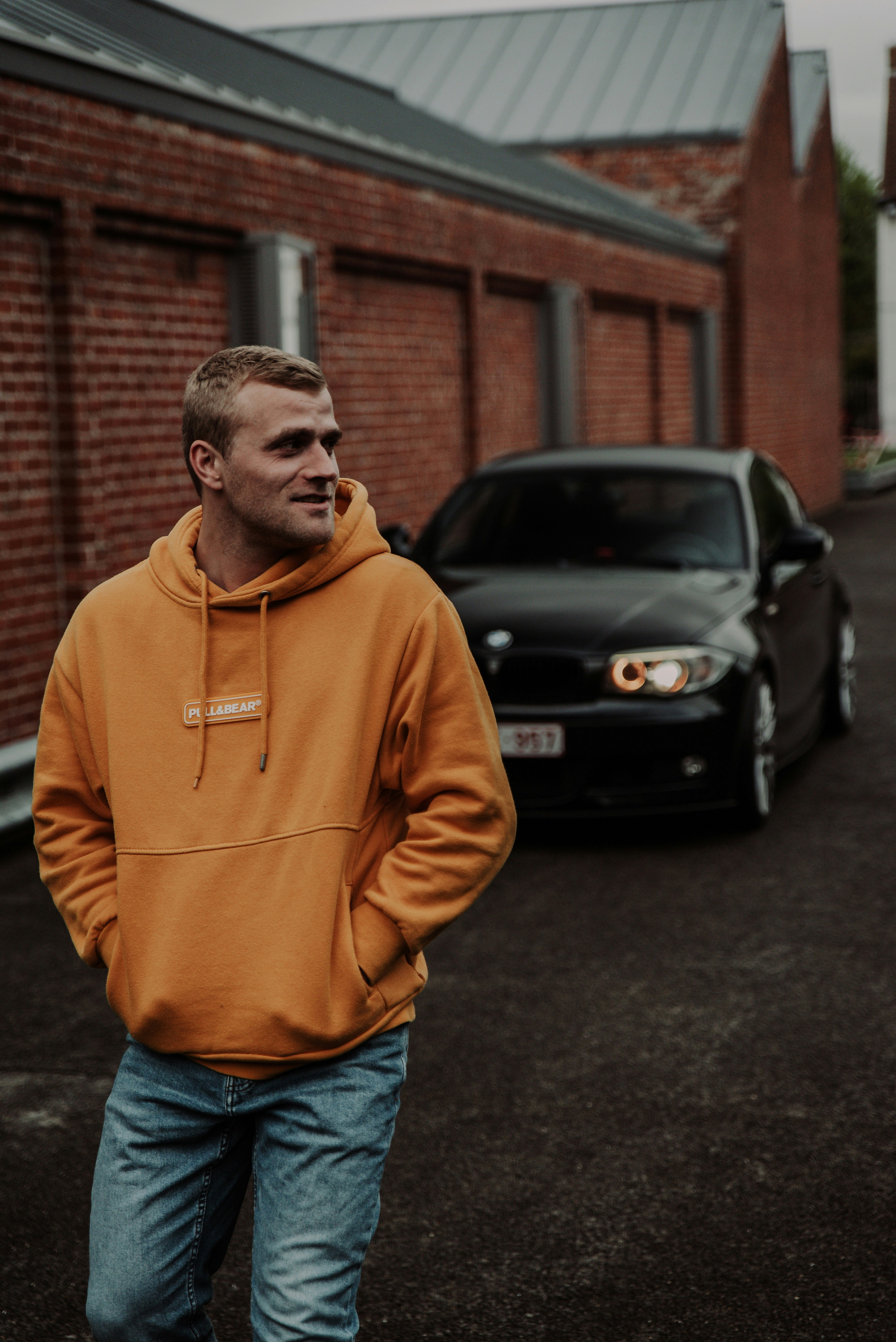 Man in brown hoodie standing near black car during daytime photo – Free Car  Image on Unsplash