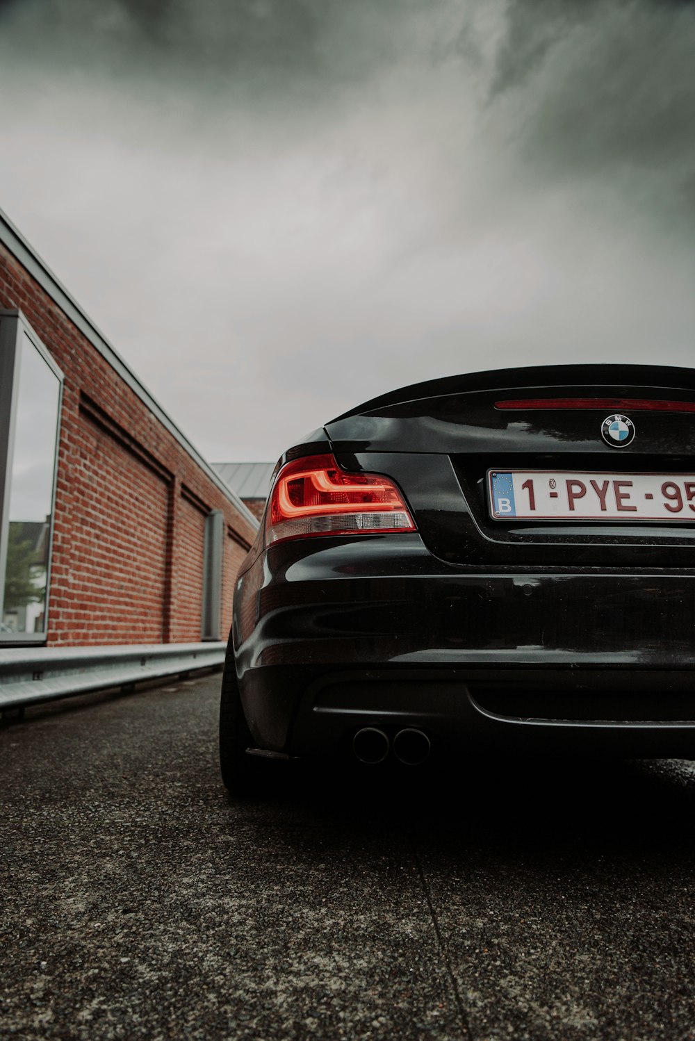 black bmw m 3 parked near brown and white house