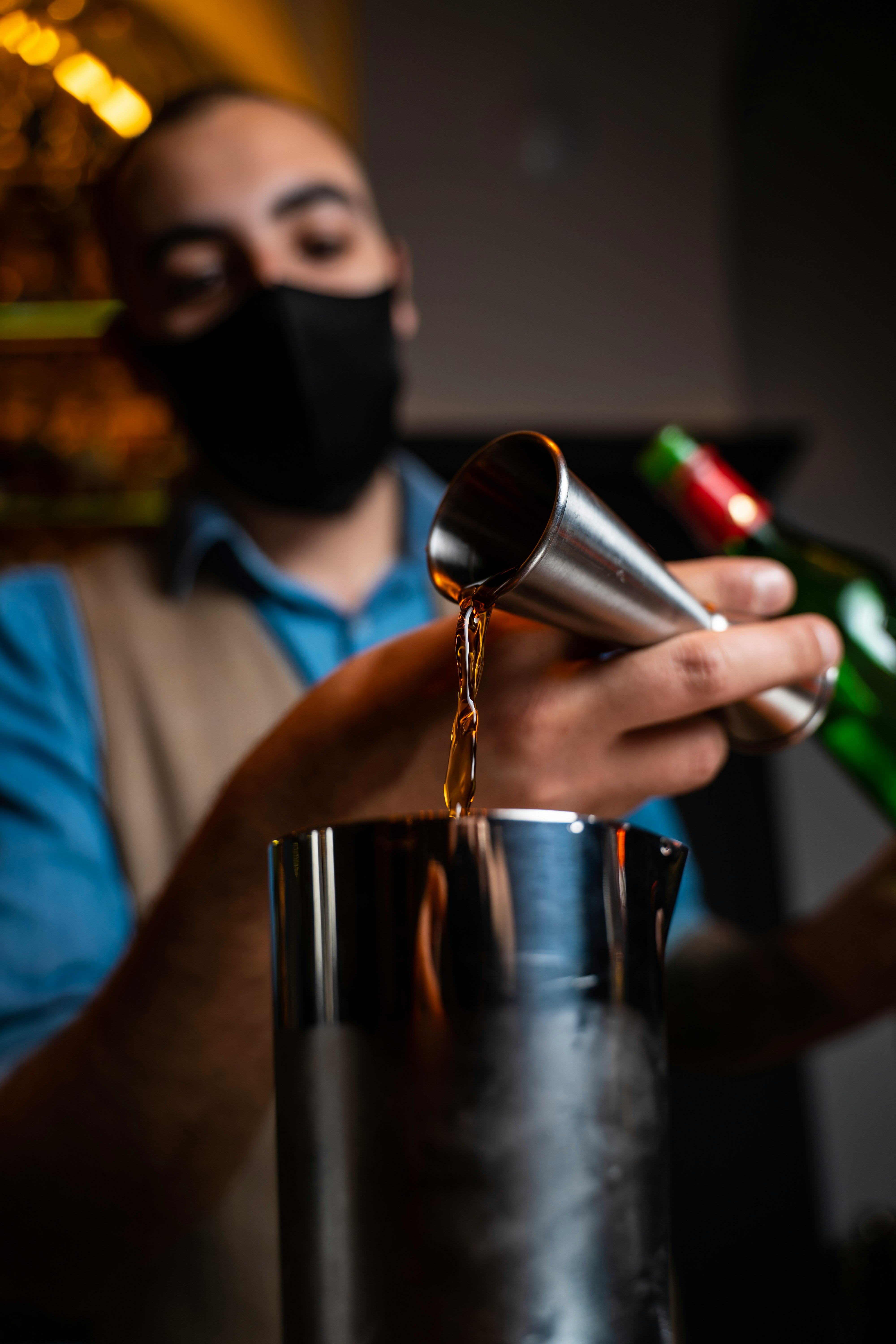 person pouring water on stainless steel cup