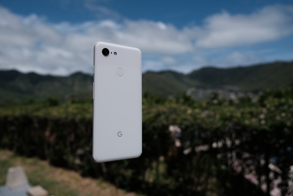 white rectangular device on green grass field during daytime