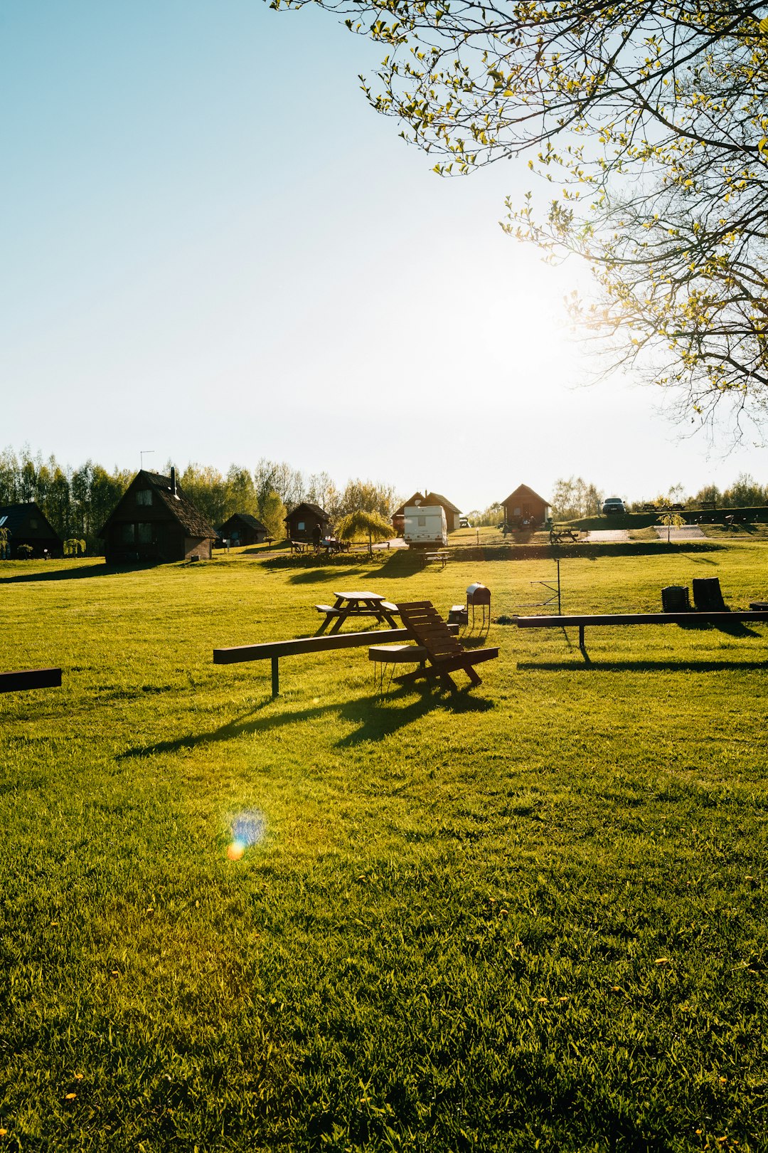 brown wooden house on green grass field during daytime