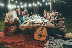 An intimate moment of friends chatting and enjoying the evening outdoors.