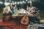 people sitting on chair in front of table with candles and candles