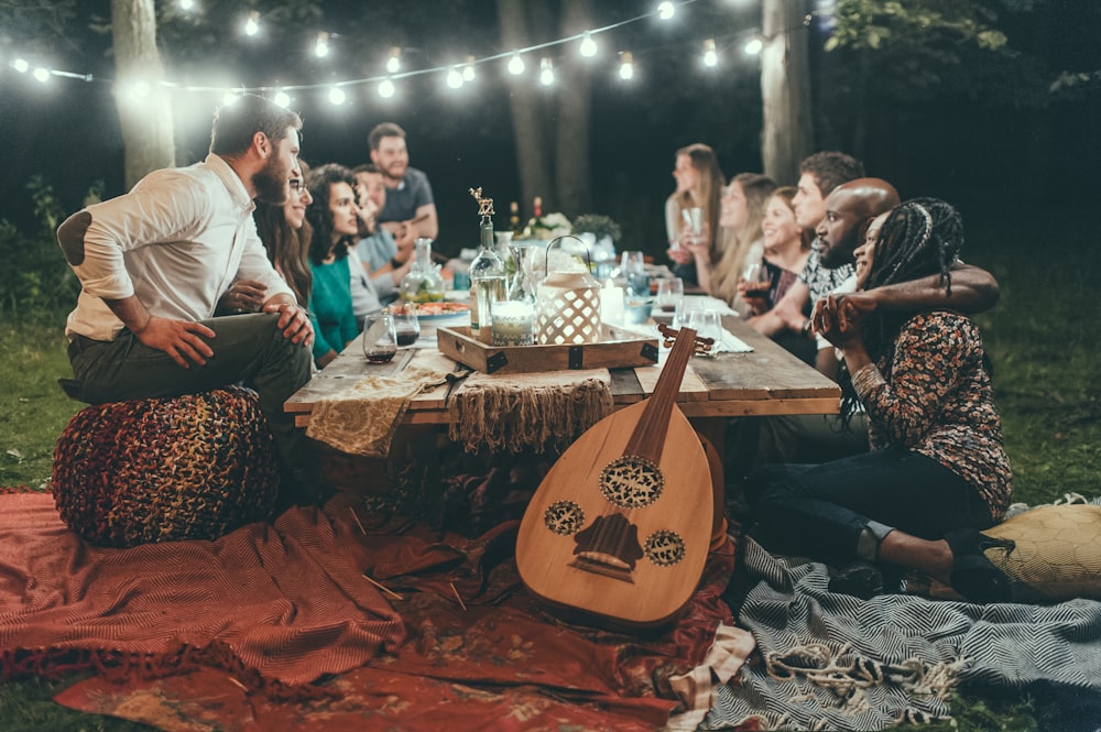 people sitting on chair in front of table with candles and candles