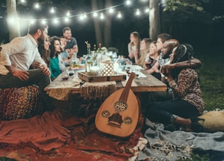 people sitting on chair in front of table with candles and candles