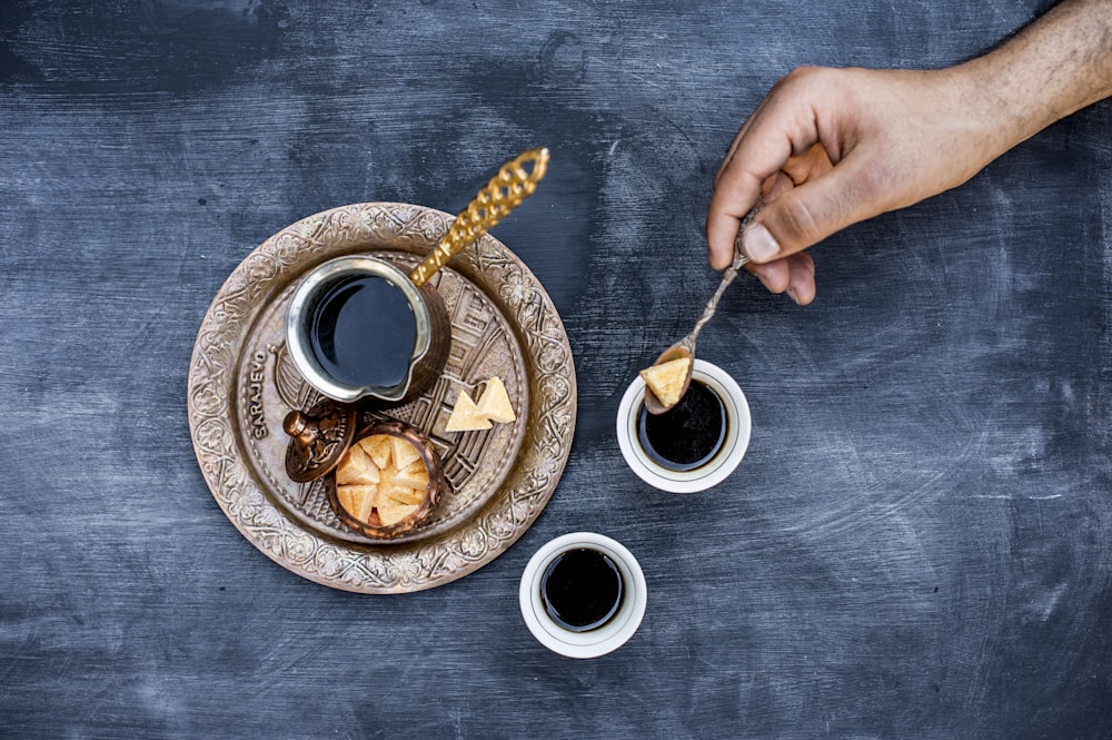 black ceramic mug on brown and white ceramic saucer