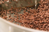 brown coffee beans in white ceramic bowl