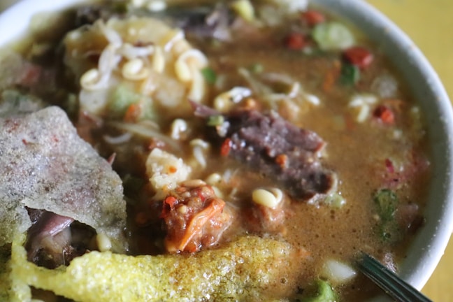 Close-up of a colorful homemade vegetable stew in a rustic bowl.
