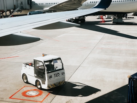 A modern airport apron with ground handling equipment in action.