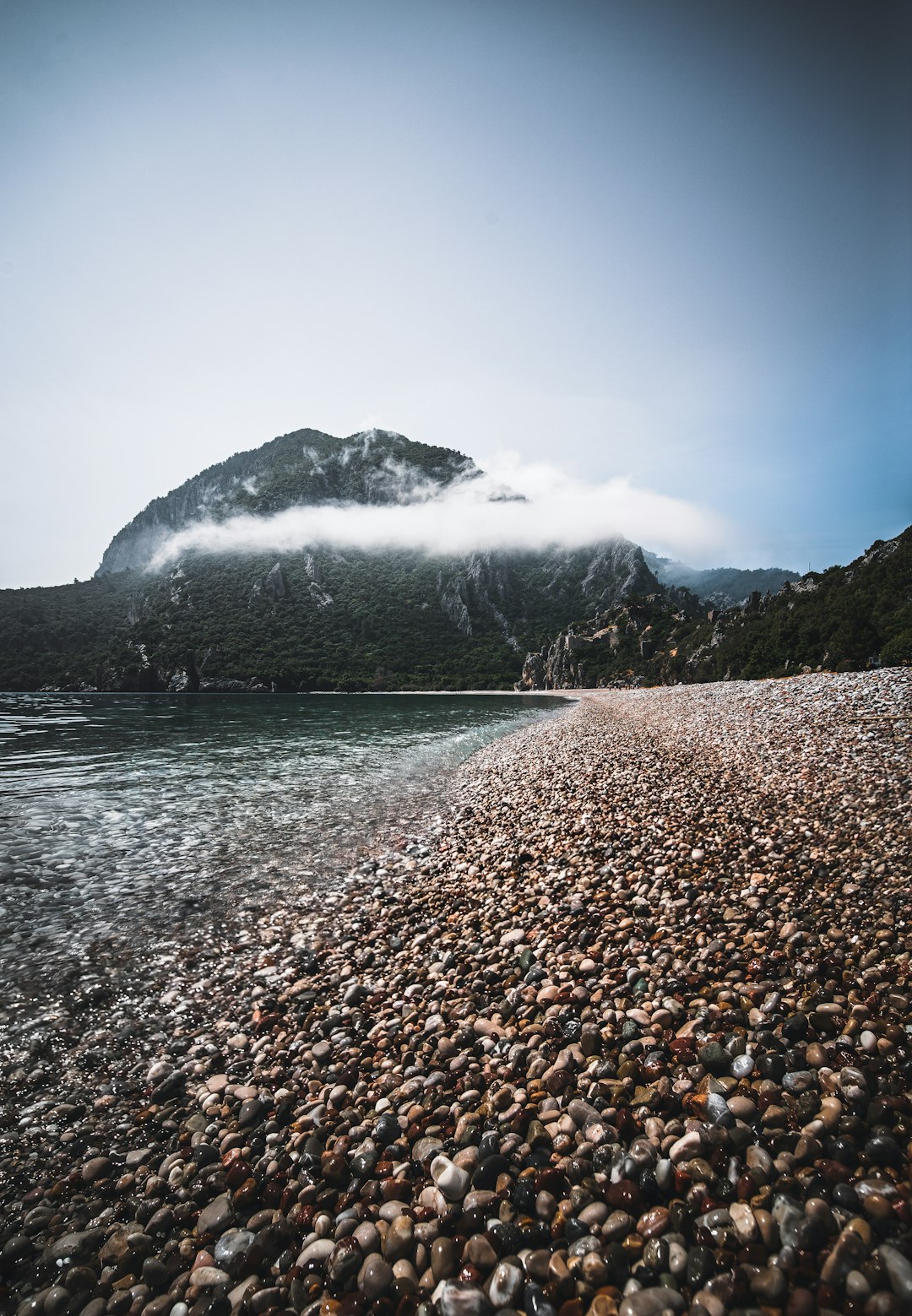 green mountain near body of water during daytime