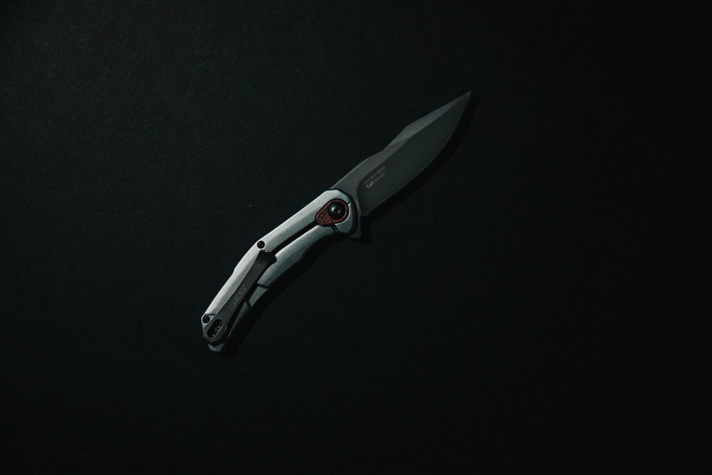 silver and black folding knife