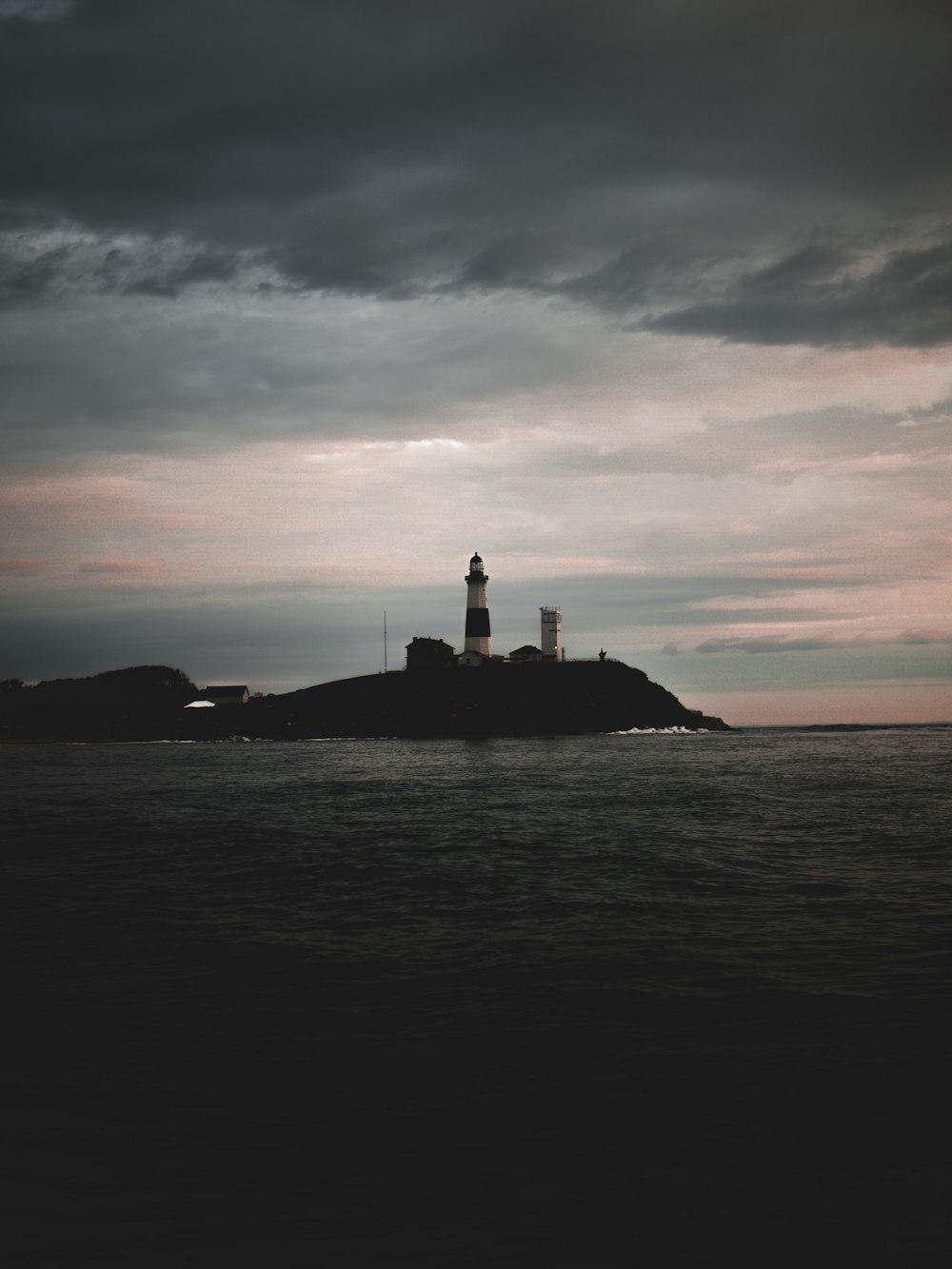 silhouette of lighthouse during sunset