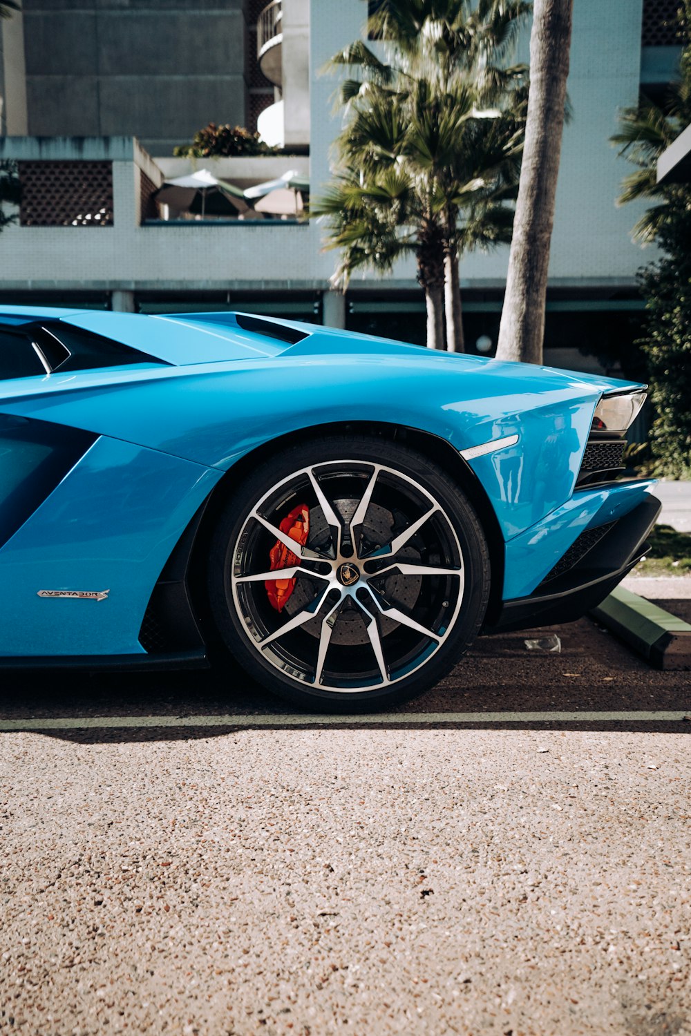 blue ferrari 458 italia parked on gray asphalt road during daytime