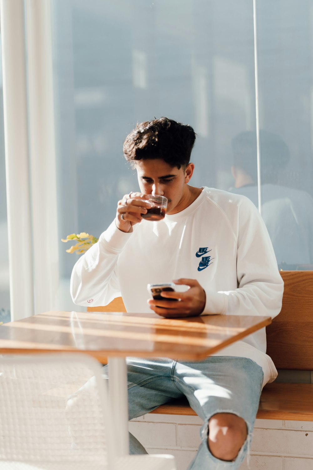 man in white long sleeve shirt sitting at table