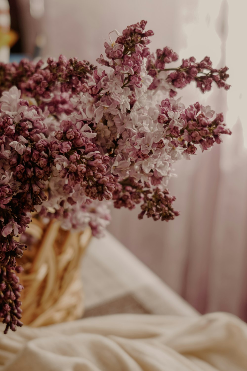 pink flowers on brown woven basket