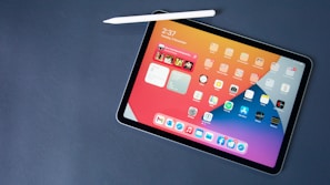 A tablet displaying the realist app interface with comics browsing on a light blue galaxy-themed background