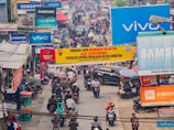 A vibrant street scene in India with people using groksafe-ai-citizen app on their phones, surrounded by saffron, white, and green hues.