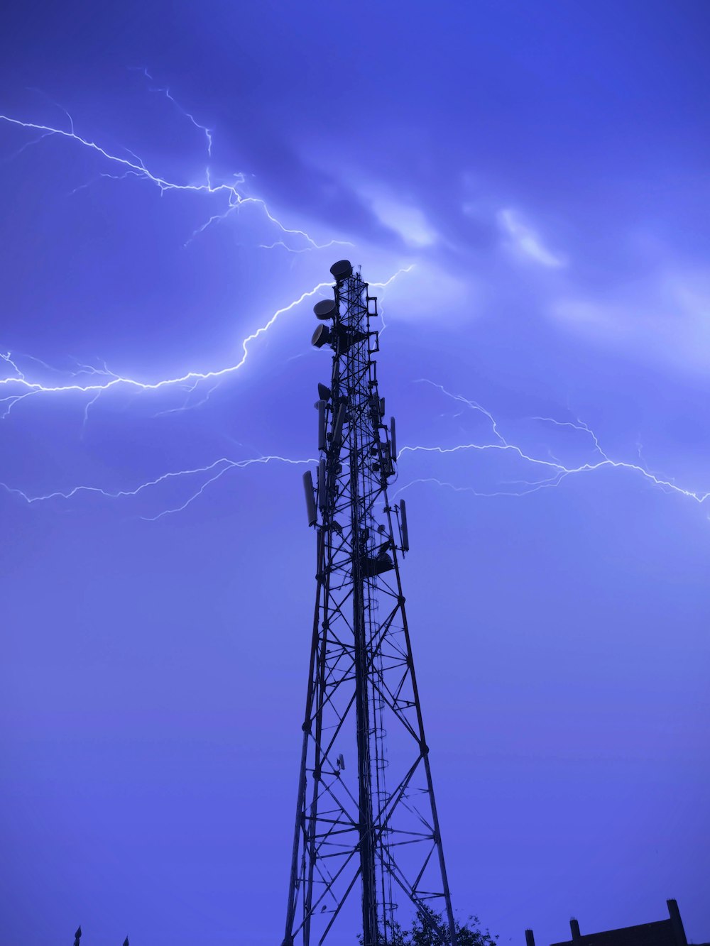 silhouette of man standing on top of tower