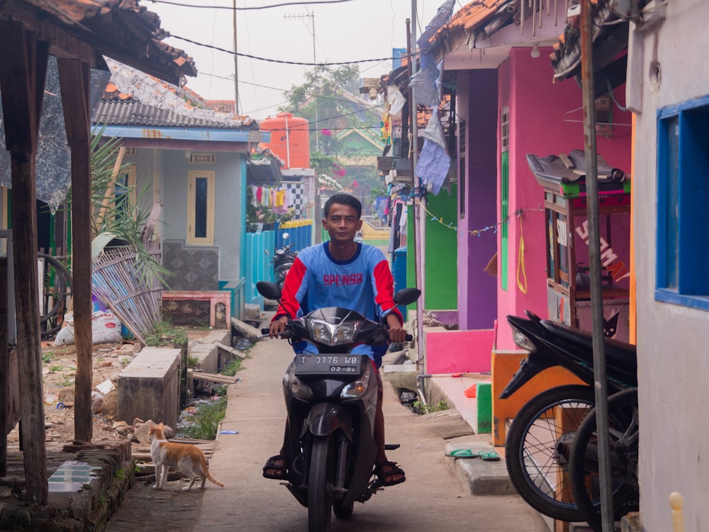 man in blue polo shirt riding black motorcycle