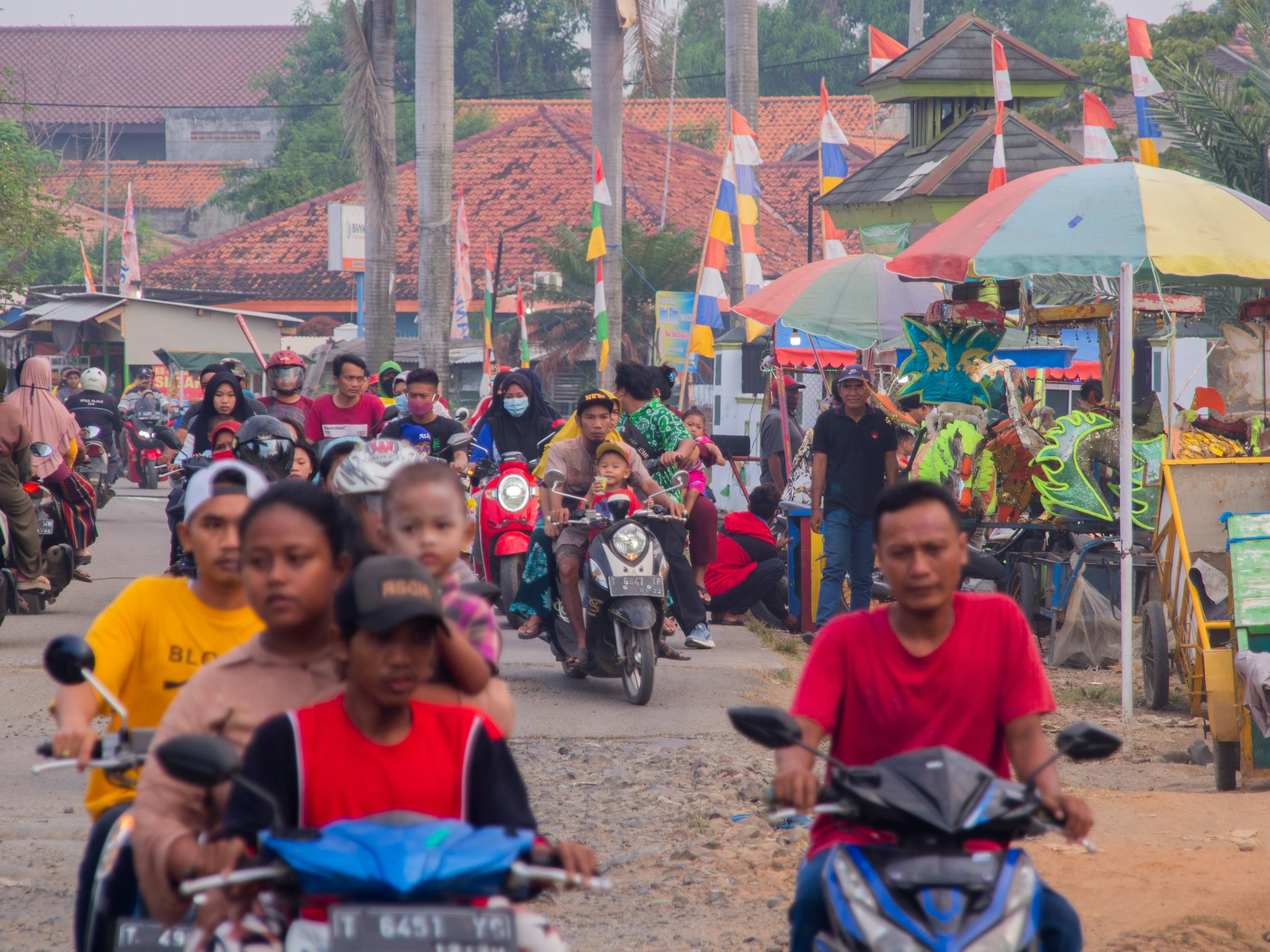 people sitting on red and black motorcycle during daytime