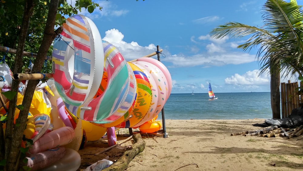 assorted color inflatable balloons on beach during daytime