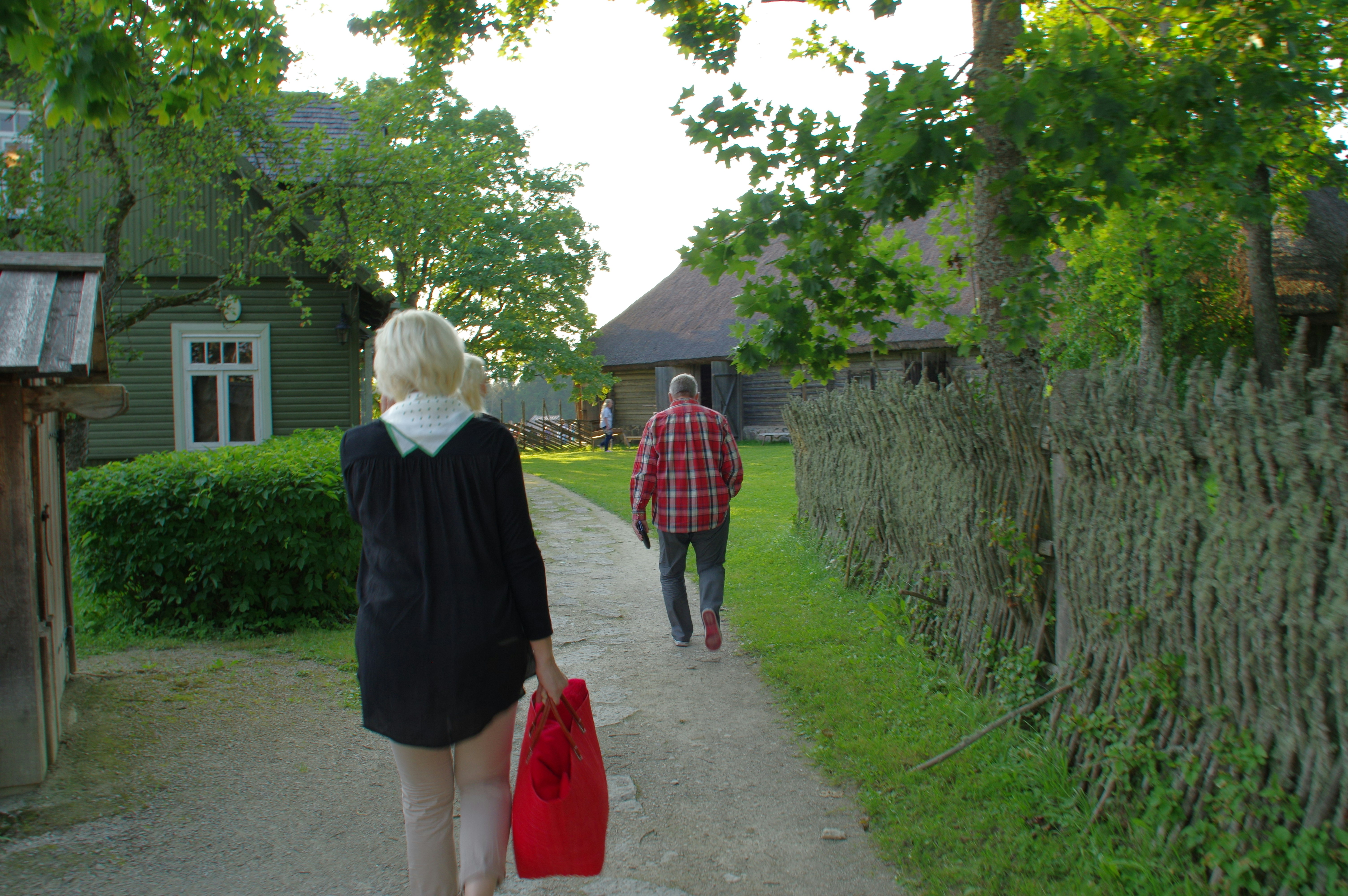 woman in black coat standing beside woman in red coat