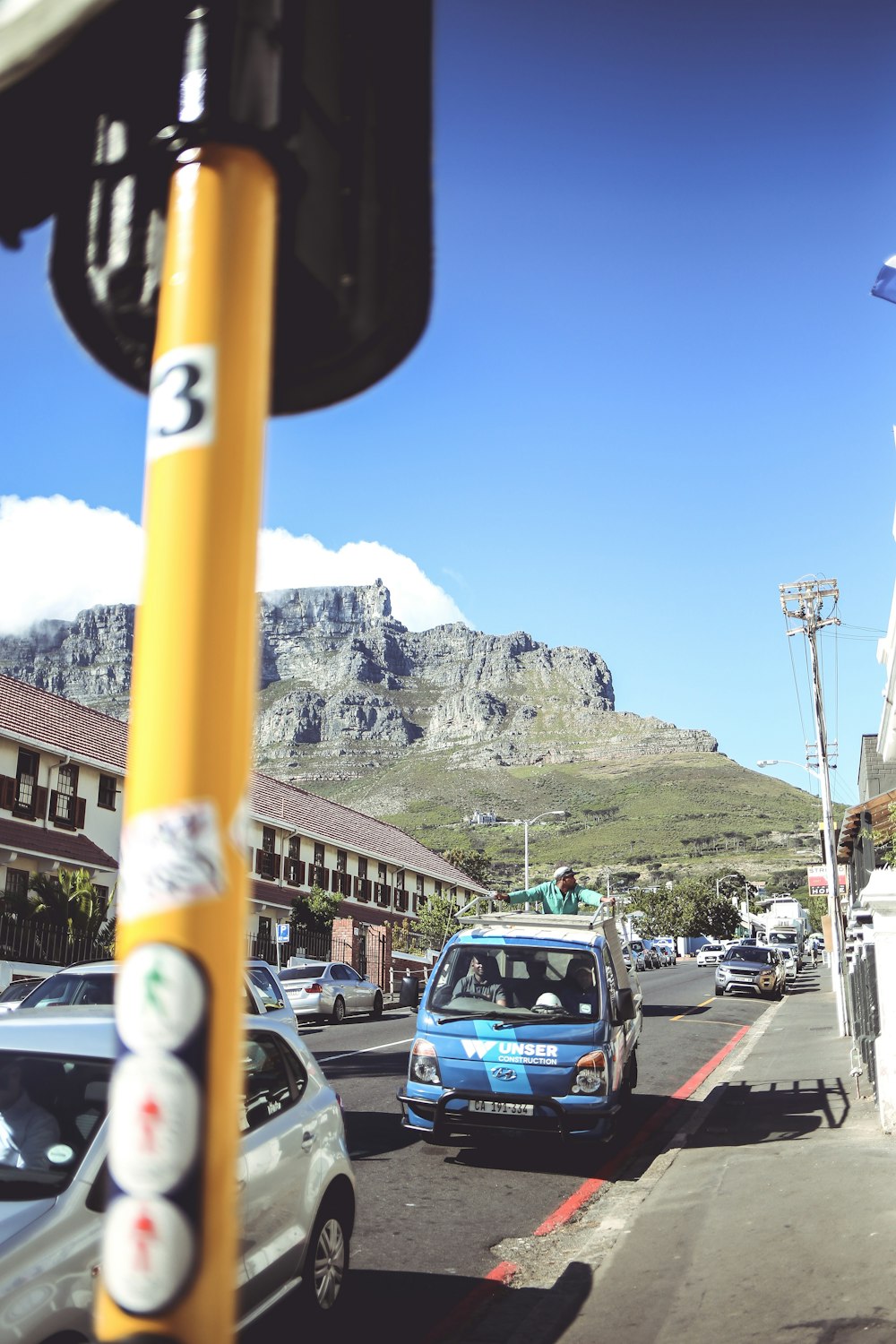 cars on road near mountain during daytime