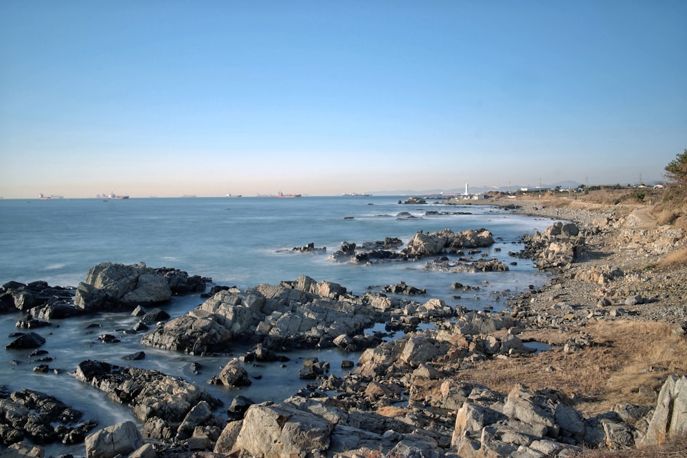 rocky shore under blue sky during daytime