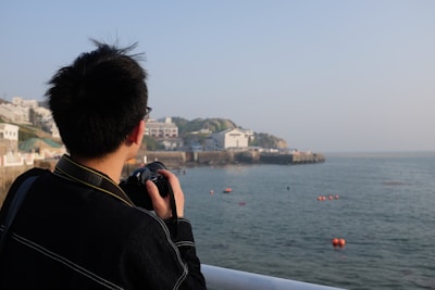 Surveyor documenting evidence of maritime accident with a camera.