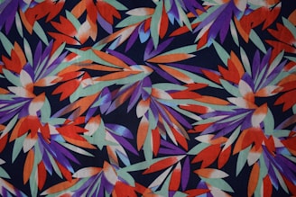 A close-up of a quirky, colorful design featuring leaves and wildlife elements.