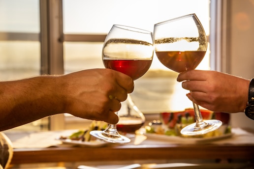 2 people holding wine glasses