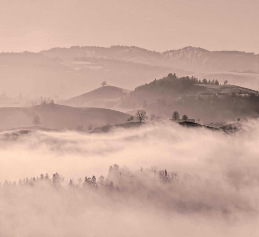 white clouds over mountains during daytime